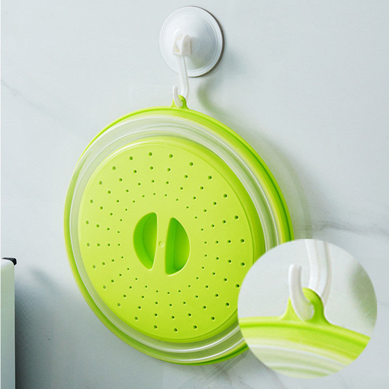 Collapsible Microwave Cover being used to rinse fruit